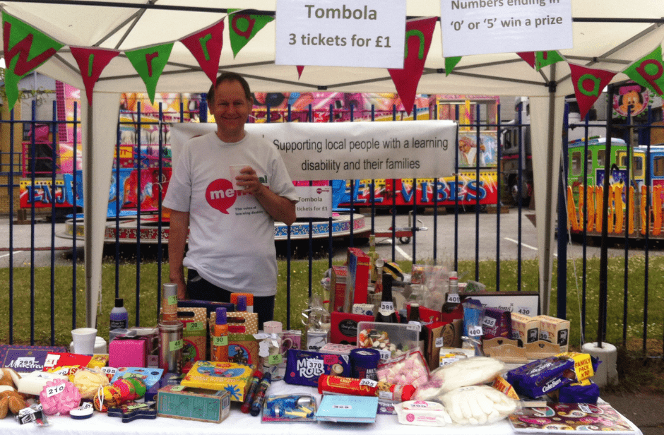 A volunteer manning the tombola stand