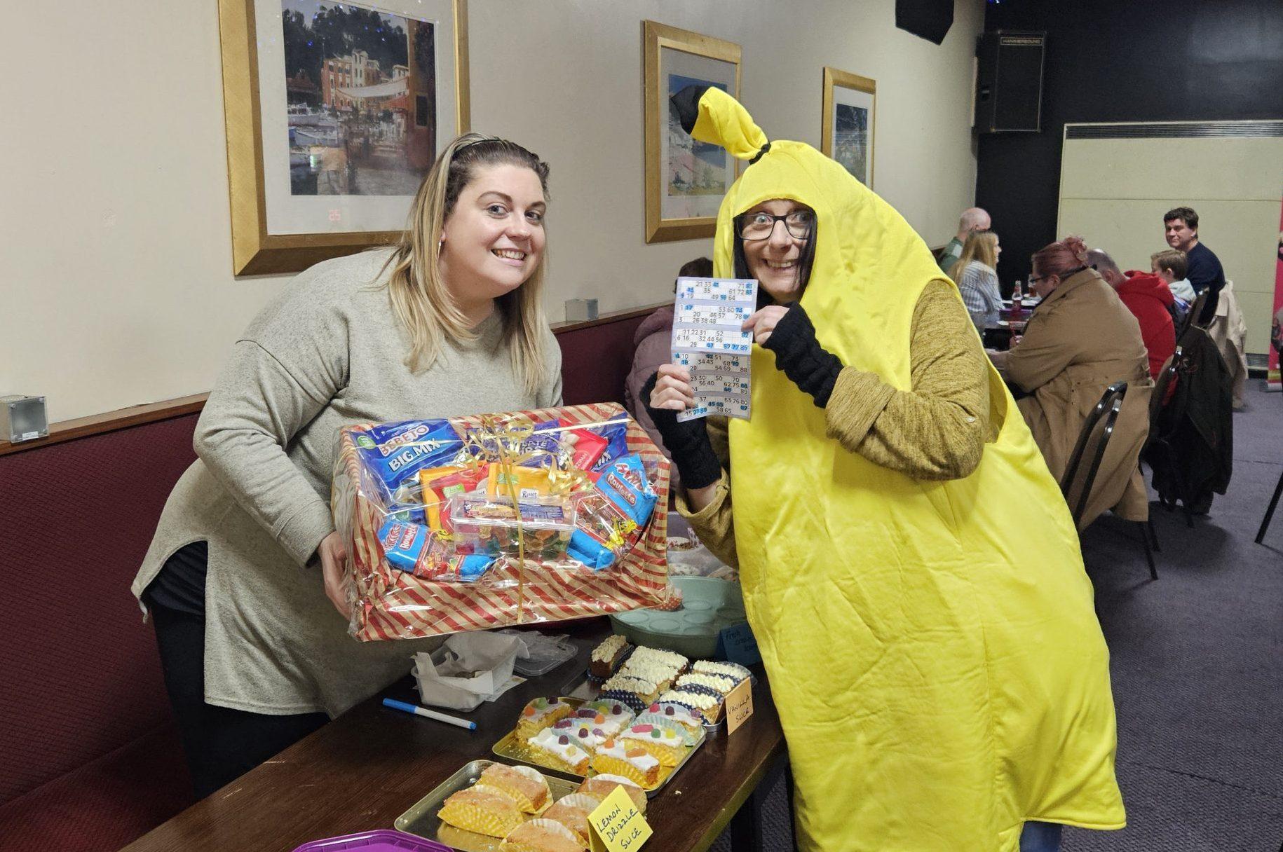 2 ladies posing with a raffle prize